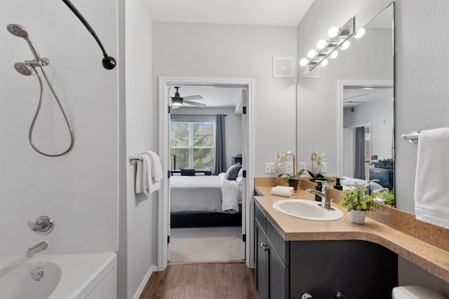 13580 Technology Dr Unit 3202, Eden Prairie, MN 55344 - ensuite bathroom featuring wood finished floors, vanity, shower / bath combination, baseboards, and a ceiling fan