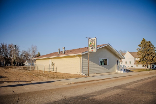 view of property exterior featuring fence