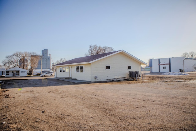 back of house with central air condition unit