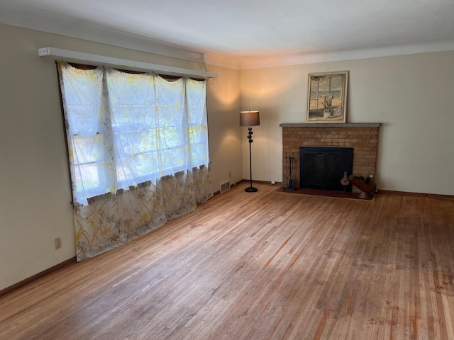 1711 Winnetka Ave N, Golden Valley, MN 55427 - unfurnished living room with wood finished floors and a brick fireplace