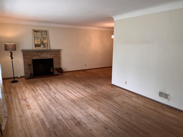 1711 Winnetka Ave N, Golden Valley, MN 55427 - unfurnished living room with wood finished floors and a brick fireplace