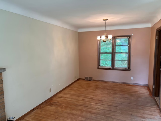 1711 Winnetka Ave N, Golden Valley, MN 55427 - spare room featuring wood finished floors and a chandelier