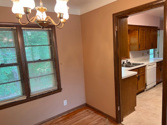 1711 Winnetka Ave N, Golden Valley, MN 55427 - kitchen with dishwasher, a chandelier, light countertops, decorative light fixtures, and light wood-style floors