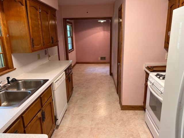 1711 Winnetka Ave N, Golden Valley, MN 55427 - kitchen featuring white appliances, brown cabinets, and light countertops