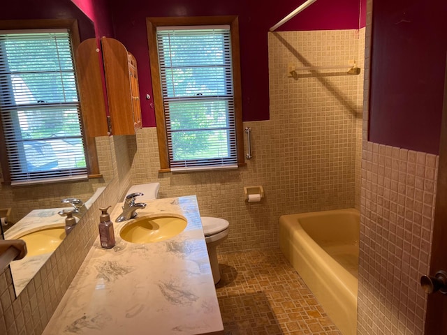 1711 Winnetka Ave N, Golden Valley, MN 55427 - bathroom featuring tile walls, plenty of natural light, double vanity, and shower / bathtub combination