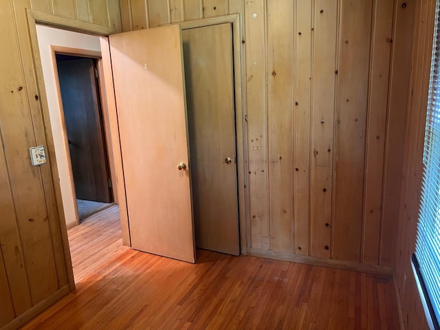 1711 Winnetka Ave N, Golden Valley, MN 55427 - unfurnished bedroom featuring hardwood / wood-style flooring, a closet, and wooden walls