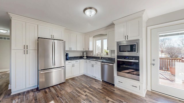 kitchen featuring white cabinetry, stainless steel appliances, and a sink