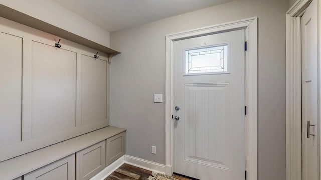 mudroom with dark wood-type flooring and baseboards