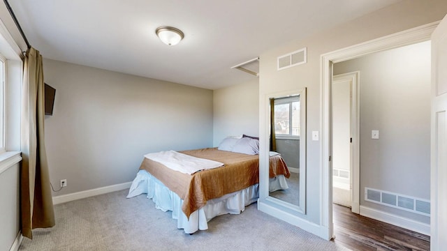 bedroom featuring visible vents, baseboards, and carpet