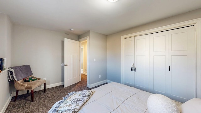 carpeted bedroom featuring a closet and baseboards