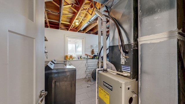 interior space with tile patterned floors, heating unit, and washing machine and clothes dryer