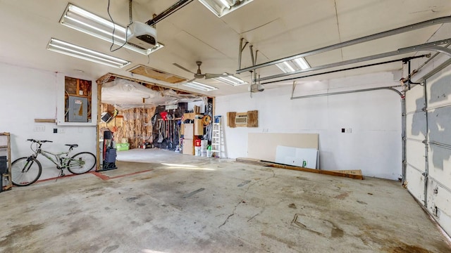 garage with electric panel, an AC wall unit, and a garage door opener