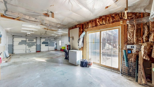 garage with refrigerator and a garage door opener