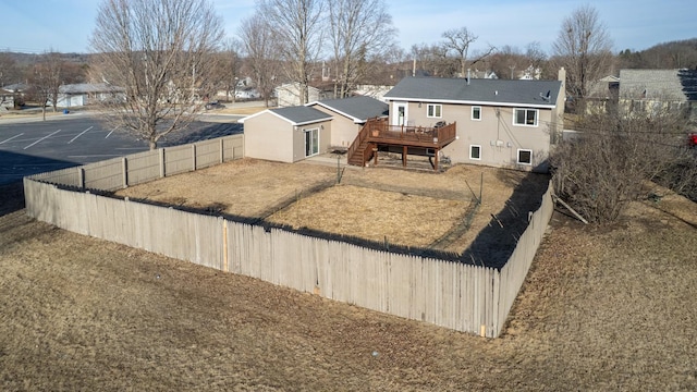 view of yard with a fenced backyard, stairs, and a deck