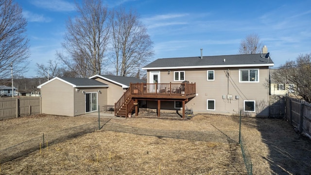 back of property featuring a wooden deck, a fenced backyard, and stairway