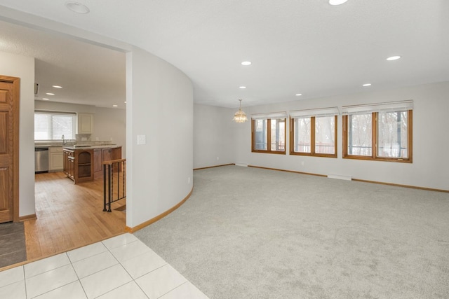 spare room with light tile patterned floors, light colored carpet, recessed lighting, and baseboards