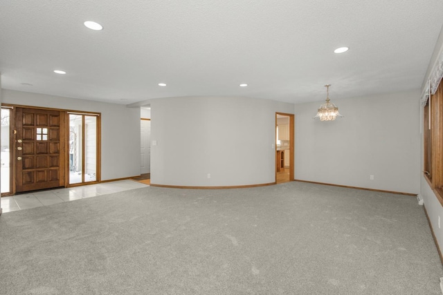 interior space with baseboards, a chandelier, light colored carpet, recessed lighting, and a textured ceiling