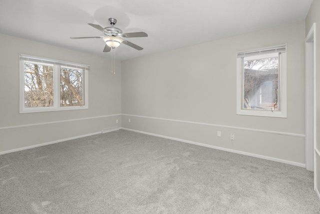 unfurnished room with carpet flooring, baseboards, and ceiling fan