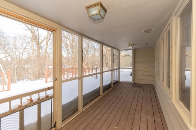 unfurnished sunroom with visible vents and a healthy amount of sunlight