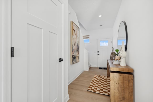 foyer with recessed lighting, baseboards, and light wood-style floors