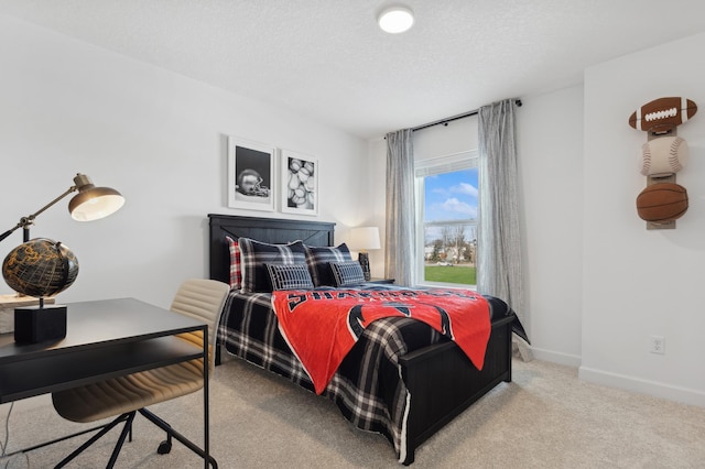 bedroom featuring baseboards, light colored carpet, and a textured ceiling