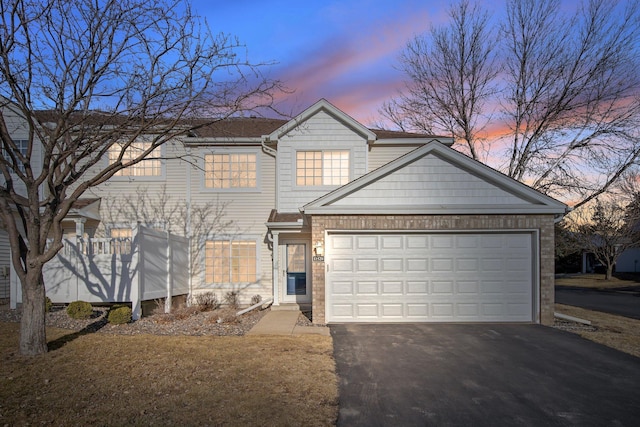 view of front of home featuring aphalt driveway and a garage