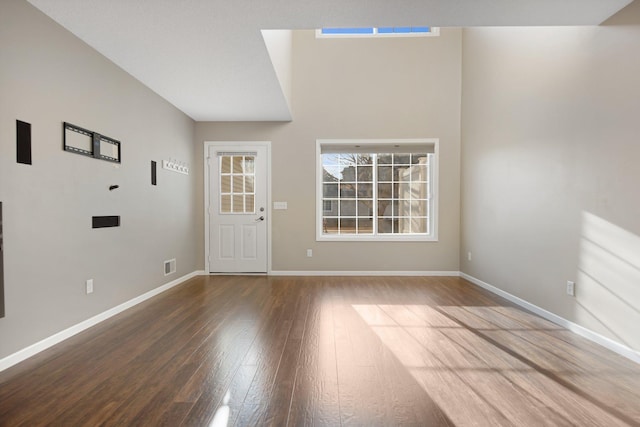 entryway featuring visible vents, wood finished floors, and baseboards