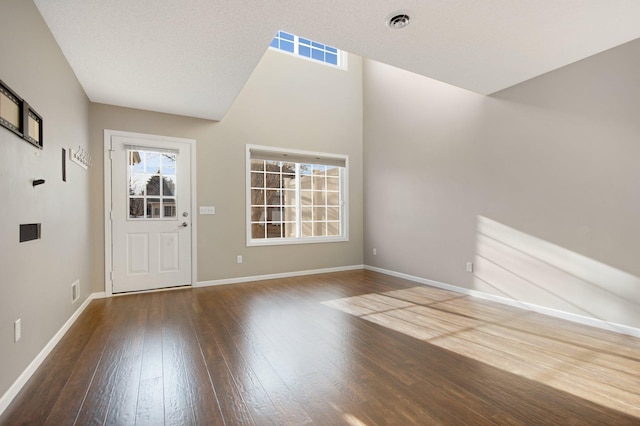 foyer entrance featuring visible vents, baseboards, and hardwood / wood-style flooring