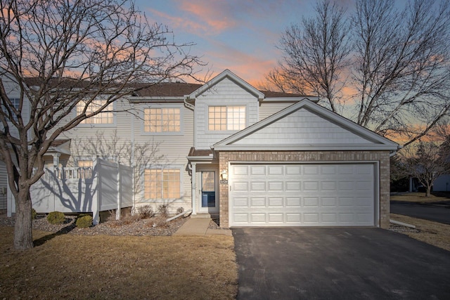 view of front of home featuring aphalt driveway and an attached garage