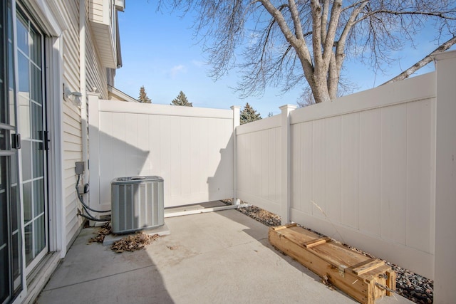 view of patio with central AC unit and a fenced backyard