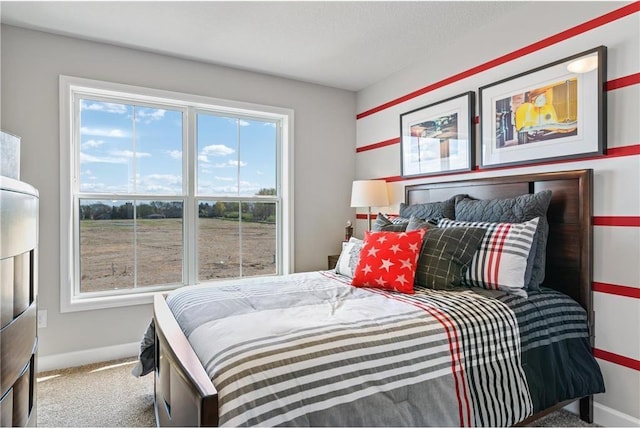 carpeted bedroom with baseboards