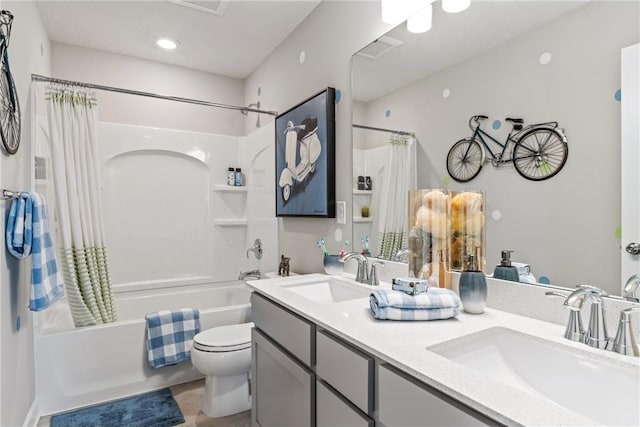 full bath featuring double vanity, shower / bathtub combination with curtain, toilet, and a sink