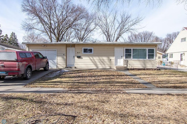 ranch-style home featuring entry steps, a garage, and driveway