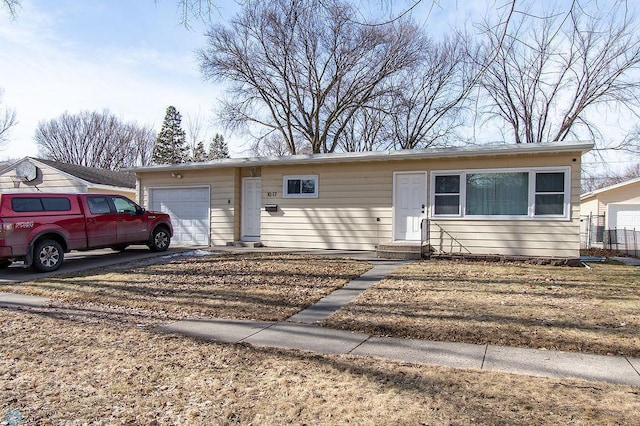 single story home featuring entry steps, an attached garage, and driveway