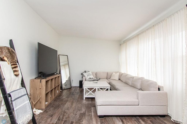 living area featuring dark wood-style floors and baseboards