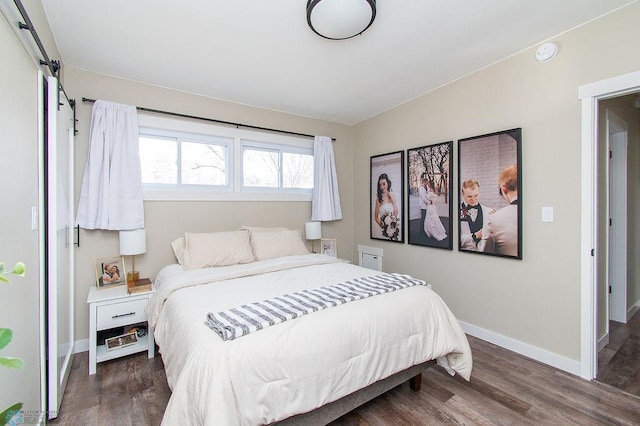 bedroom featuring wood finished floors and baseboards