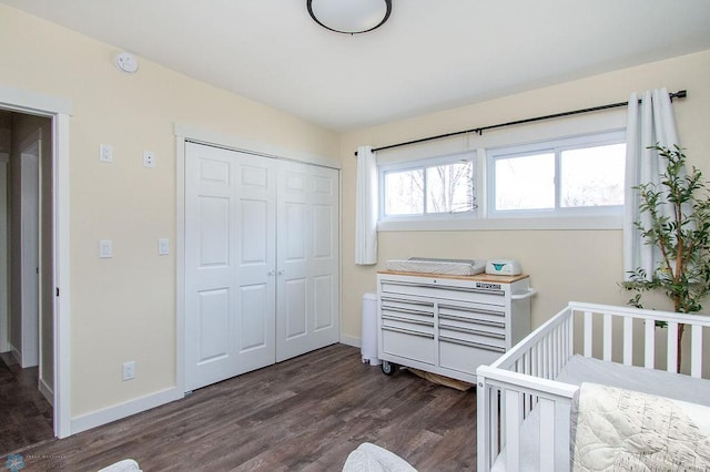 bedroom featuring a closet, baseboards, and dark wood-style flooring