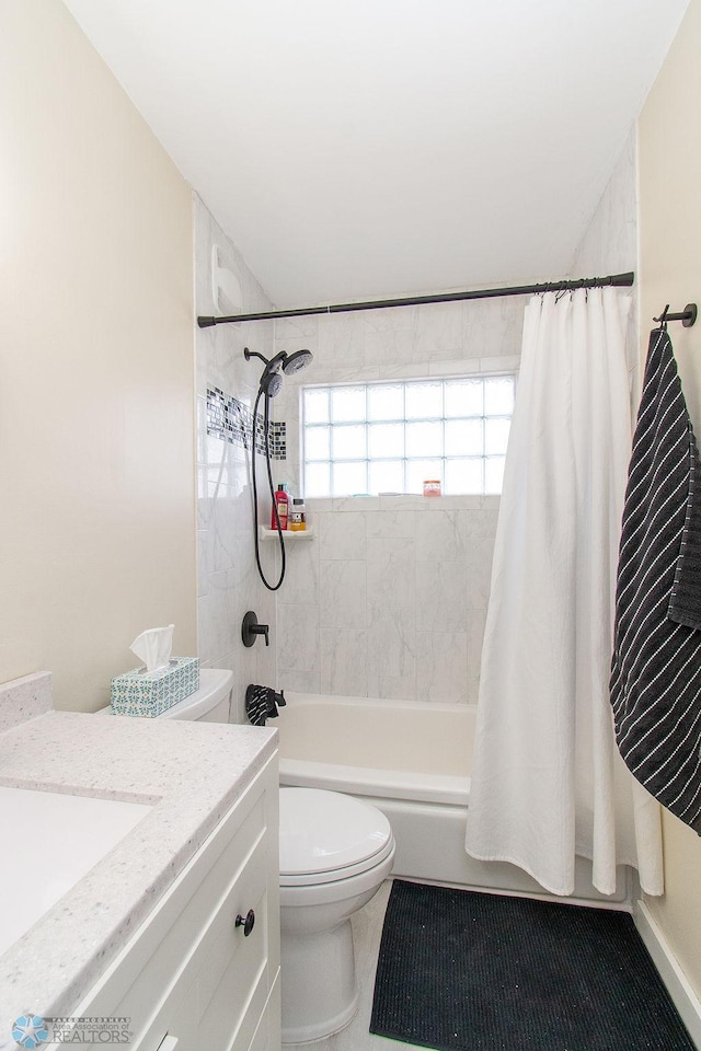 bathroom with vanity, toilet, and shower / tub combo with curtain