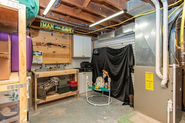 unfinished basement featuring heating unit