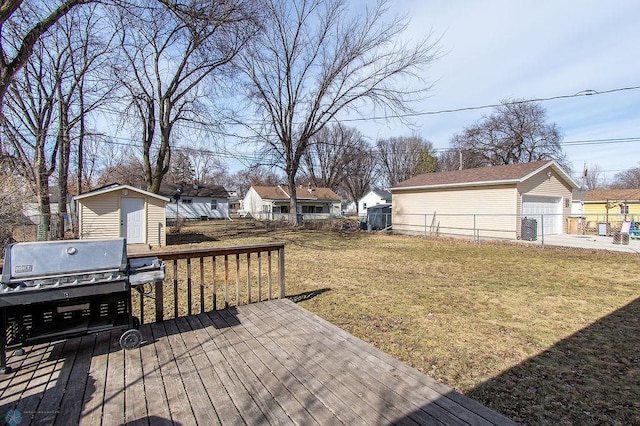 wooden terrace with an outbuilding, a yard, fence, and a grill