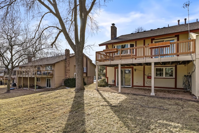 back of house with a deck and a chimney