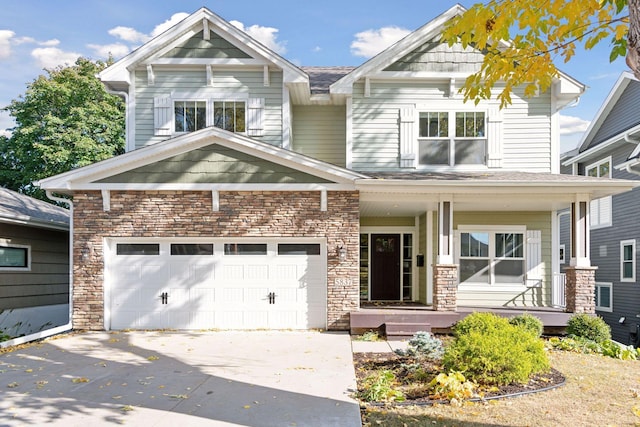 craftsman-style home with concrete driveway, covered porch, and stone siding