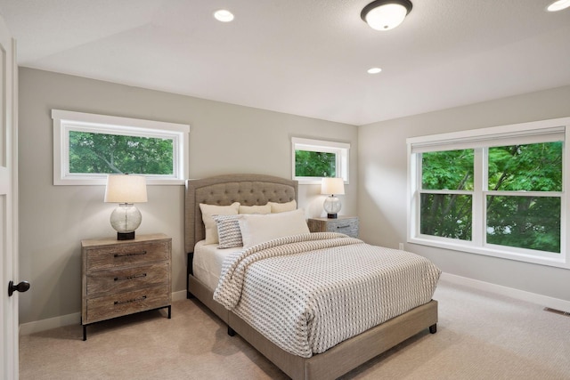 bedroom with visible vents, recessed lighting, light colored carpet, and baseboards