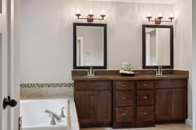 full bathroom featuring double vanity, a garden tub, and a sink