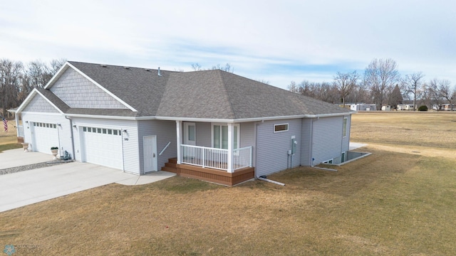 view of front facade with a porch, a shingled roof, driveway, and a front yard