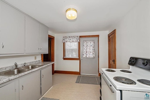 3729 2nd St, Superior, WI 54880 - kitchen with white electric range, a sink, light countertops, and baseboards