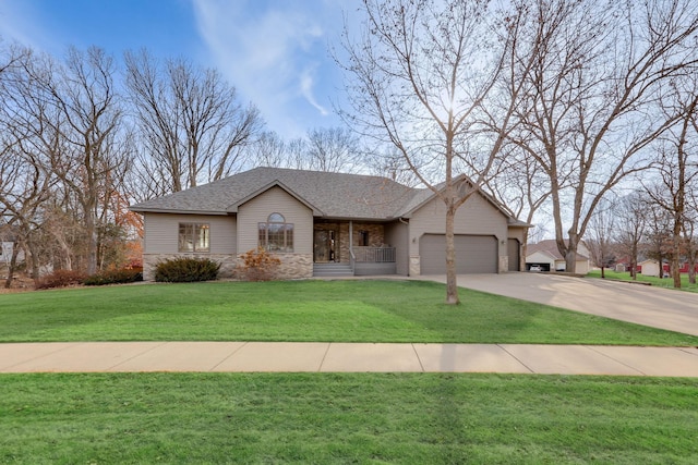 ranch-style house featuring a front yard, roof with shingles, concrete driveway, a garage, and brick siding