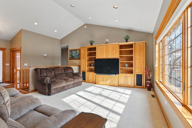 living area with visible vents, high vaulted ceiling, recessed lighting, baseboards, and light colored carpet