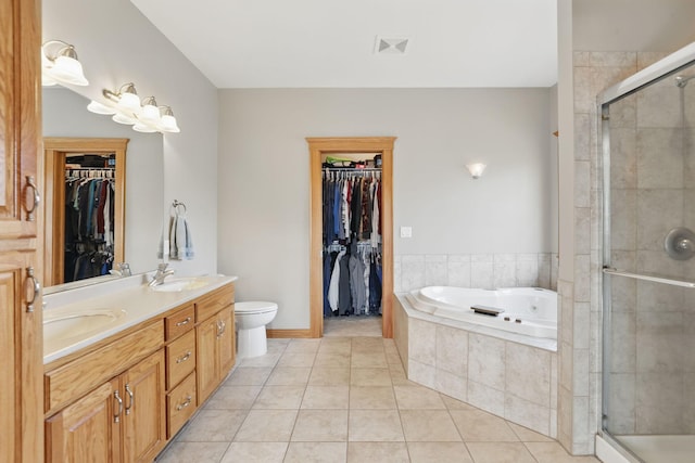 bathroom with a stall shower, a bath, visible vents, and a sink