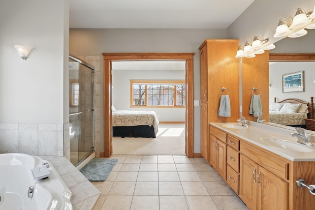 ensuite bathroom with ensuite bath, a shower stall, and a sink